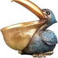 estatua decorativa de pelícano turquesa con función de cuenco organizador