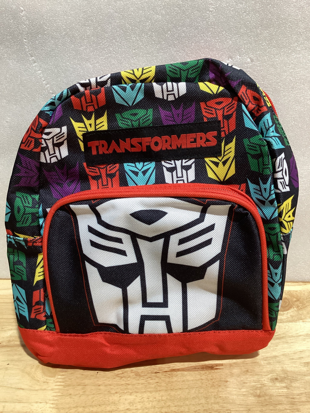 Transformers Mini mochila – Mochila pequeña tejida exclusiva de 10 pulgadas con bolsillo frontal y paquete de botones | Se ajusta para adaptarse a adultos, adolescentes, niños