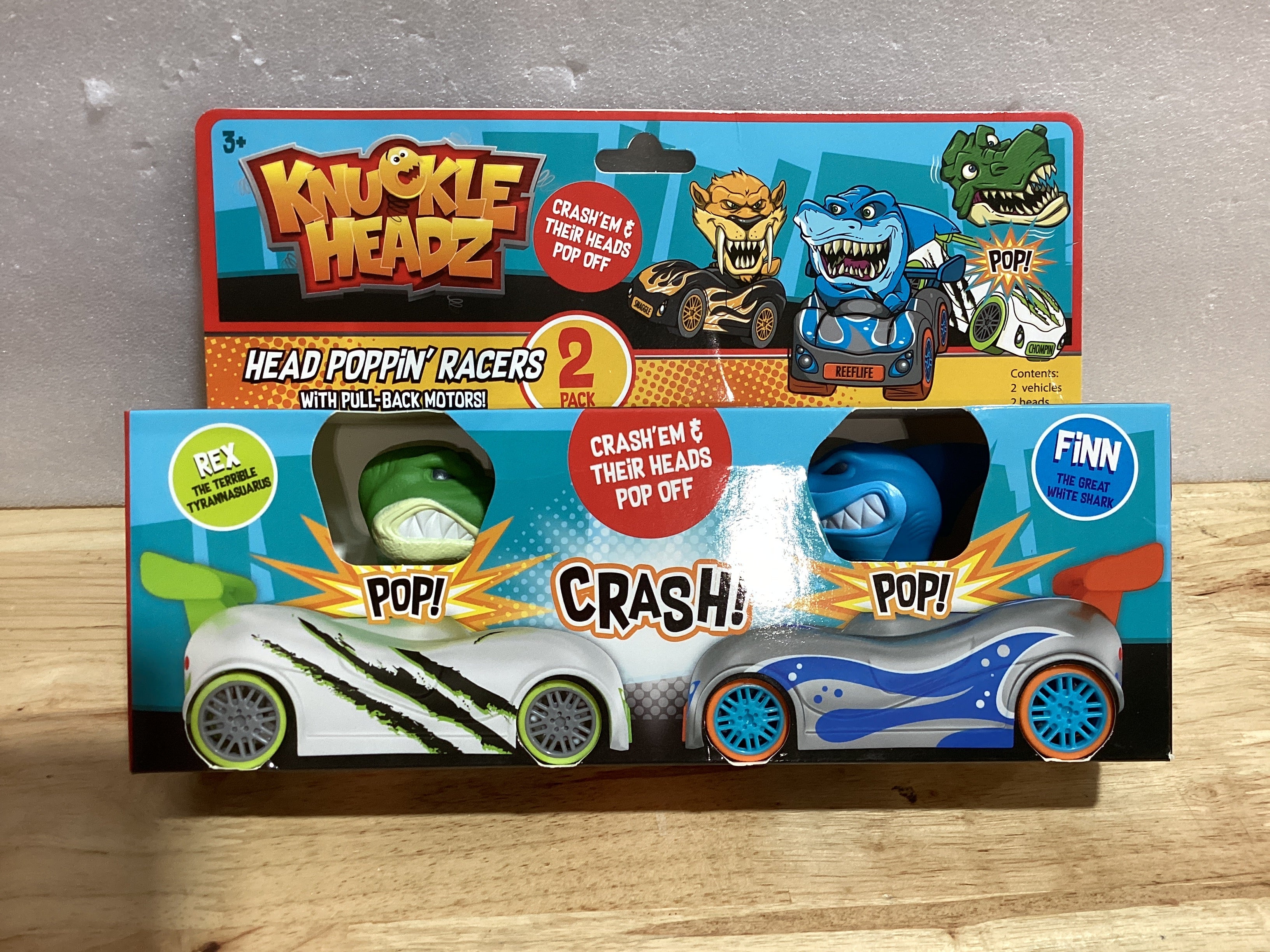 Knuckle Headz Duo Head Poppin' Quick Shot Pull Back Crash Derby Racers - Finn el Tiburón y Rex el Dinosaurio